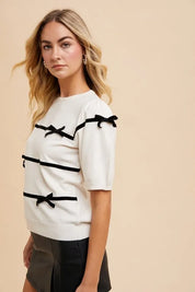 Annie Wear Striped Bow Round Neck Knit Top | Tops Daverri Fashions