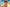 Woman wearing a women's floral dress walking on the beach-DAVERRI FASHIONS