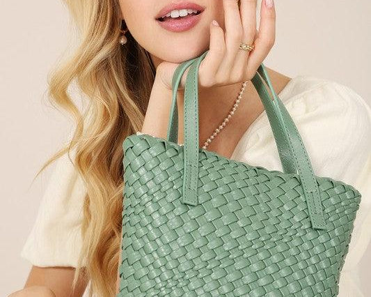 Woman holding a sage colored handwoven vegan leather mini tote-fashion blog-DAVERRI FASHIONS