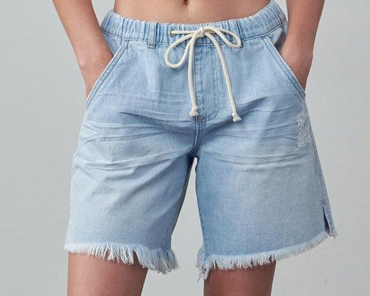 Woman wearing a pair of drawstring waist denim shorts -DAVERRI FASHIONS