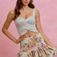 Light gray knitted crop top with twisted front and SO ME floral print skirt