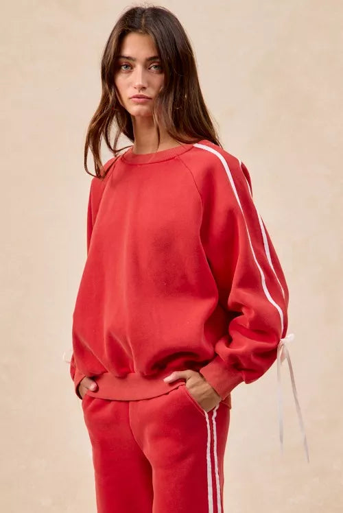Red BiBi fleece sweatshirt with white side stripes and bow details