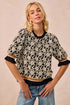 Black and cream floral BiBi rose knit top with ruffled puff sleeves