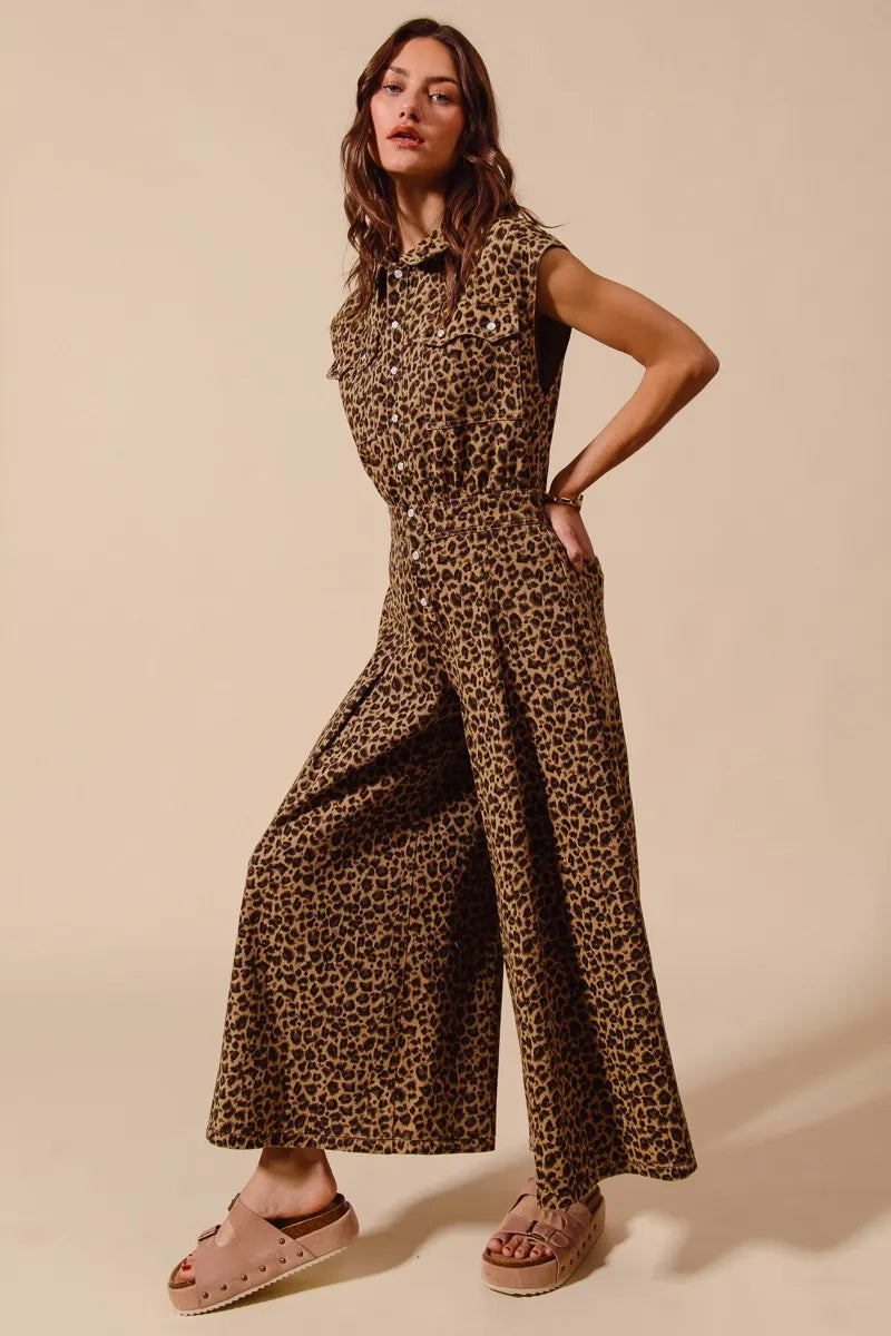 Woman wearing a leopard print jumpsuit on a beige background