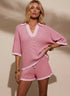 Pink and white striped knit two-piece set with collared V-neck top