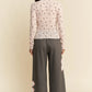 Soft pink long-sleeved Davi & Dani blouse with black cross pattern and lace hem