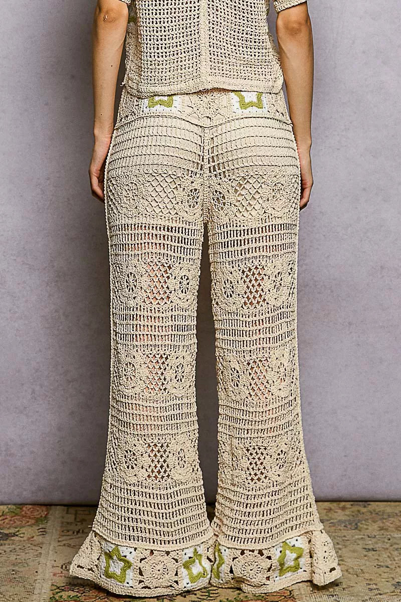 Cream-colored POL openwork crochet flare pants with green floral accents