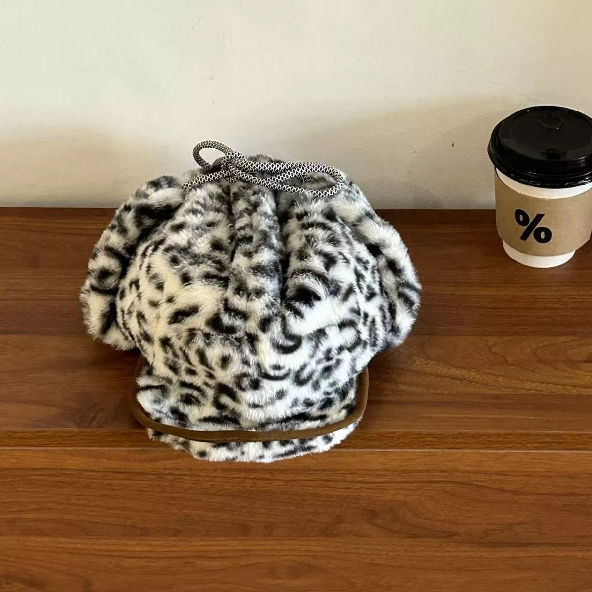Cozy leopard print faux fur bucket bag with drawstring and leather trim