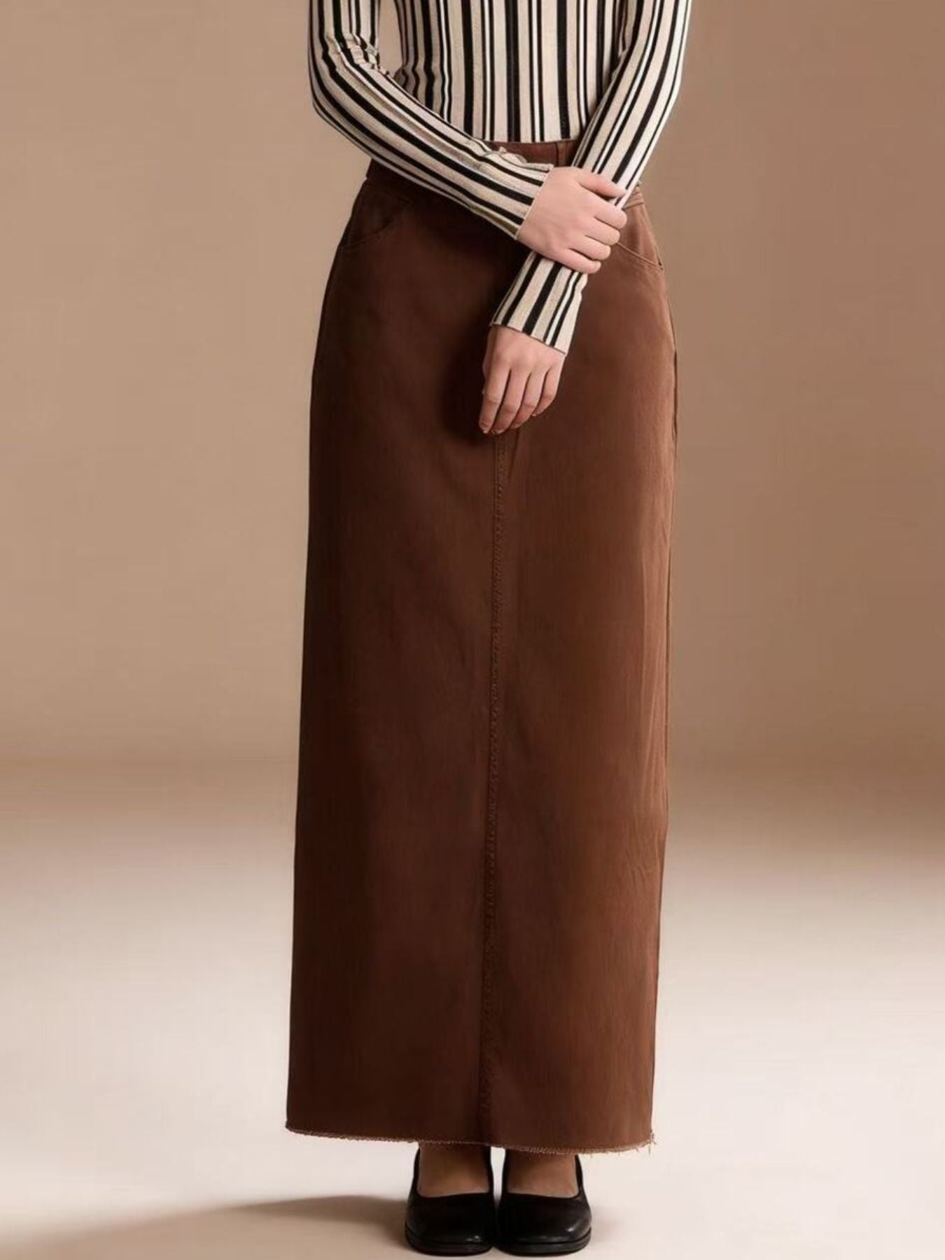 Raw hem maxi denim skirt with straight-cut full-length brown fabric and front seam