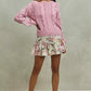Soft pink cable-knit sweater with ribbed hem on SO ME floral skirt
