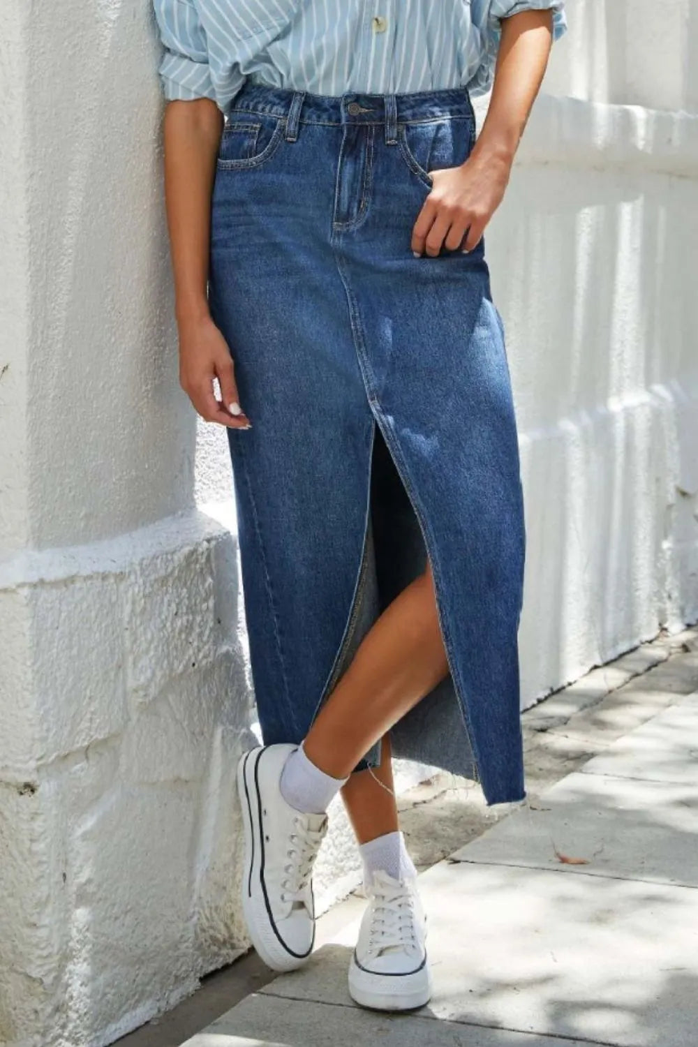 Mid-rise denim midi skirt with front slit and raw hem