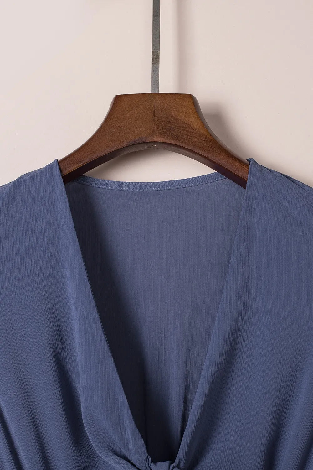 Soft blue ribbed tie-front mini dress with smocked waist and deep V-neck