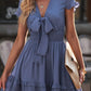 Soft blue tie-front mini dress with smocked waist and bow