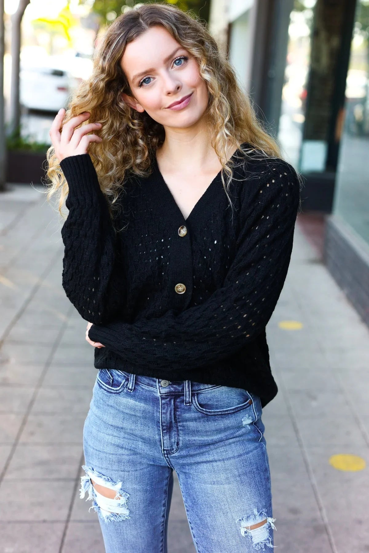 Black sequined Follow Me pointelle knit cardigan with gold buttons and distressed jeans