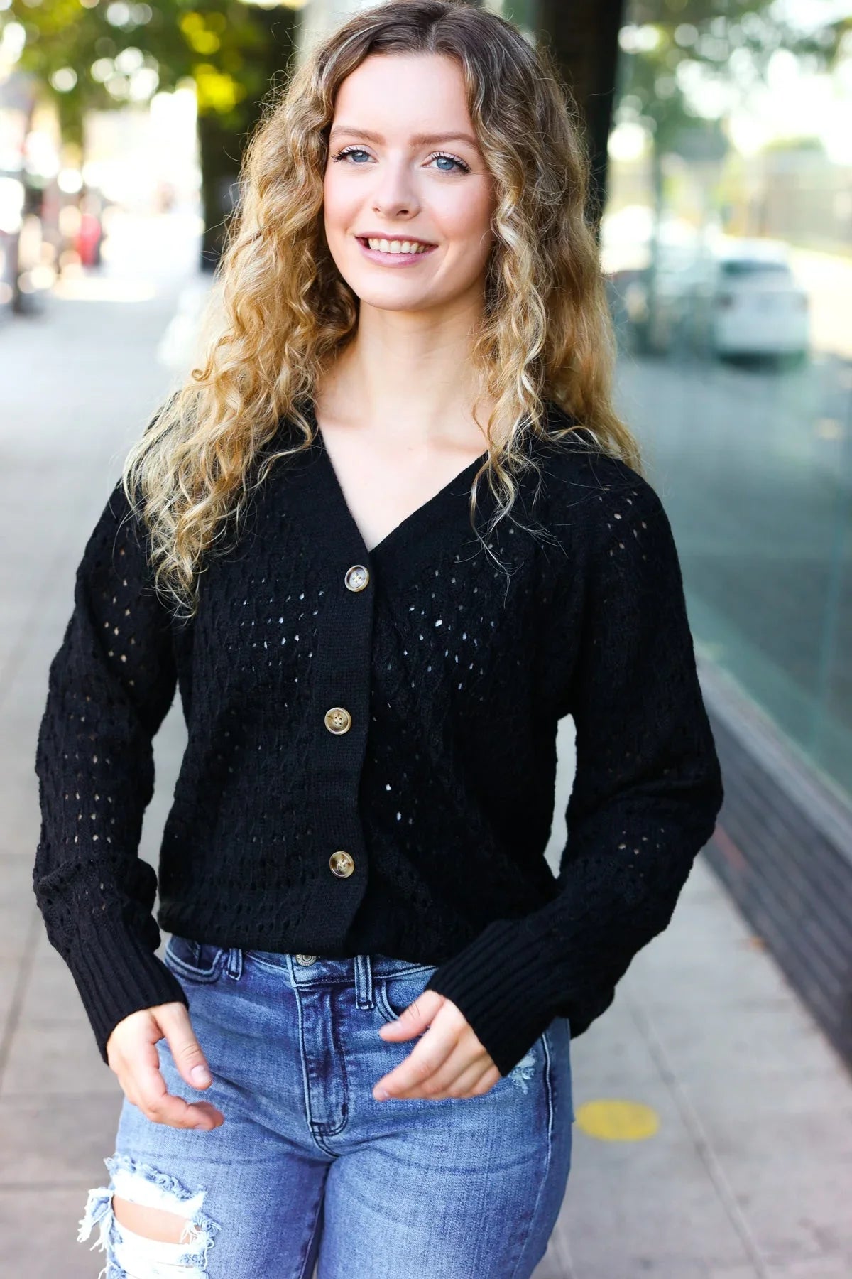 Black Follow Me pointelle knit cardigan with gold buttons and eyelets