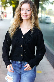 Black Follow Me pointelle knit cardigan with gold buttons and eyelets