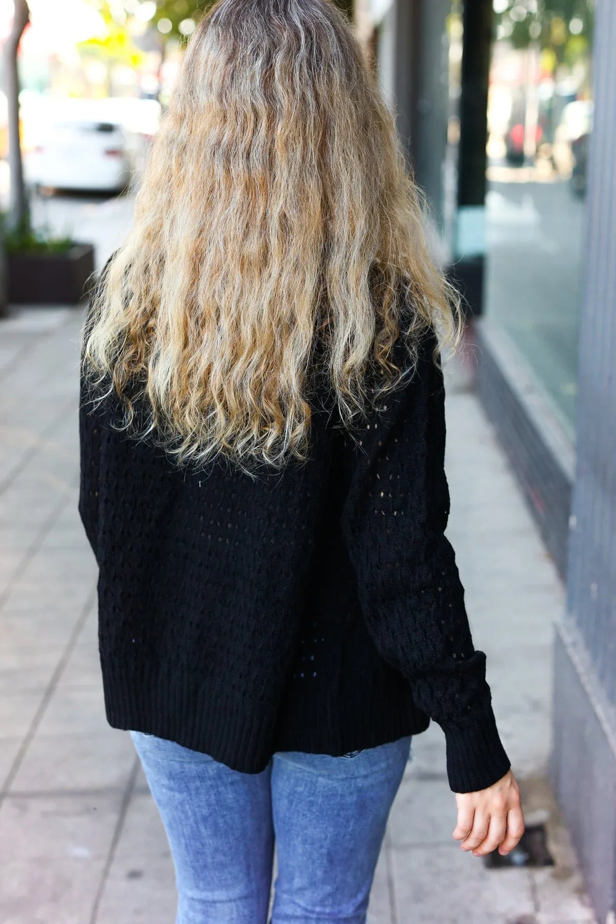 Black cable knit cardigan with glitter accents and pointelle details