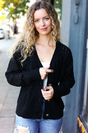 Black pointelle knit button-down cardigan with gold buttons and pockets