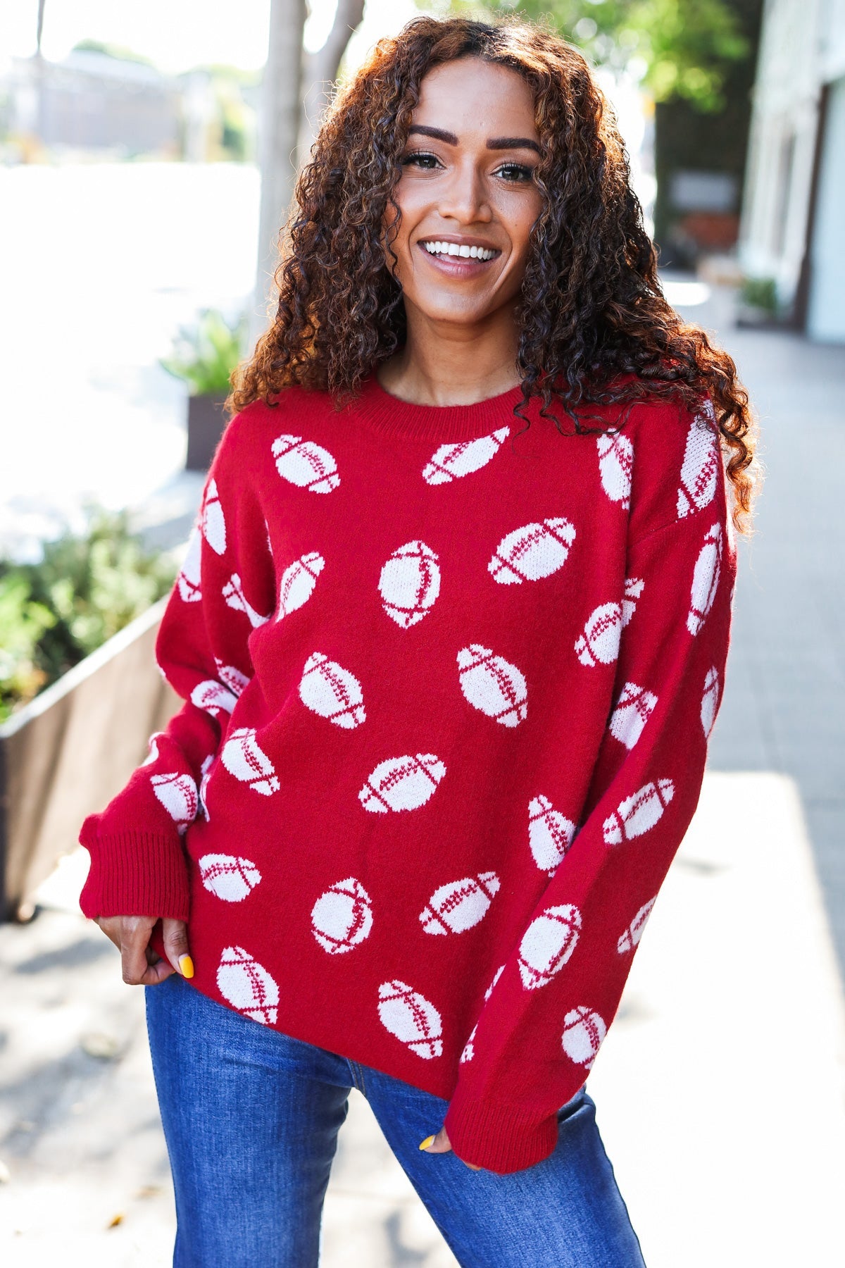 Red football print jacquard knit sweater with white stitched details