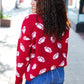 Red knit sweater with white football patterns, Haptics Game Day jacquard