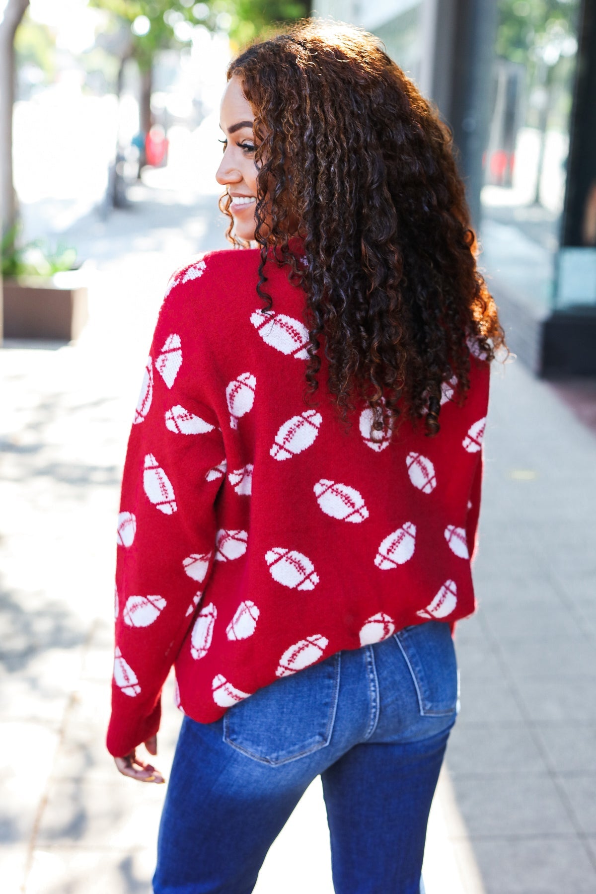 Red knit sweater with white football patterns, Haptics Game Day jacquard
