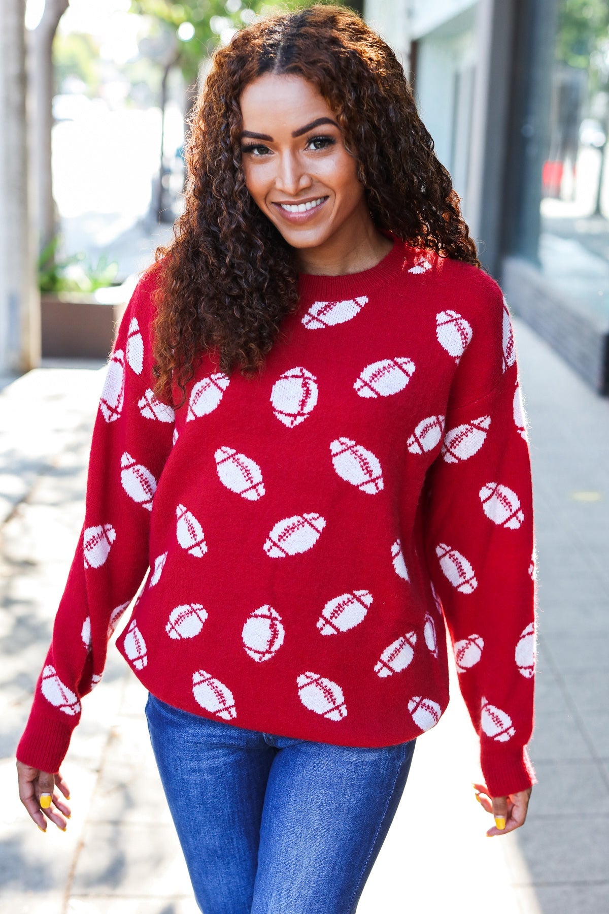 Red knit sweater with white football patterns, Haptics Game Day jacquard