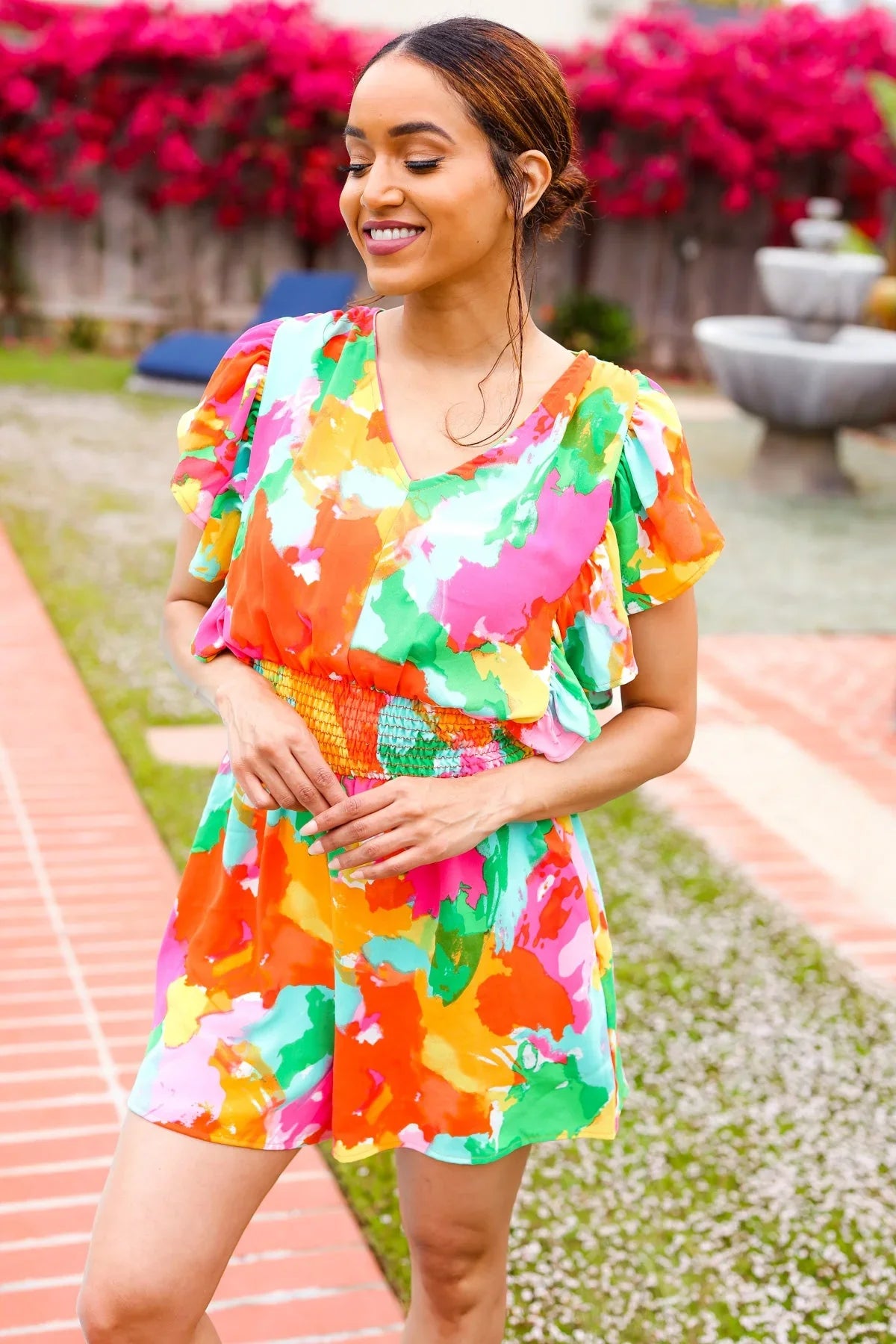 Vibrant tie-dye abstract floral smocked waist V-neck romper with ruffled flutter sleeves