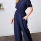 Dark Blue Smocked Waist Notch Neck Crepe Jumpsuit - DAVERRI FASHIONS