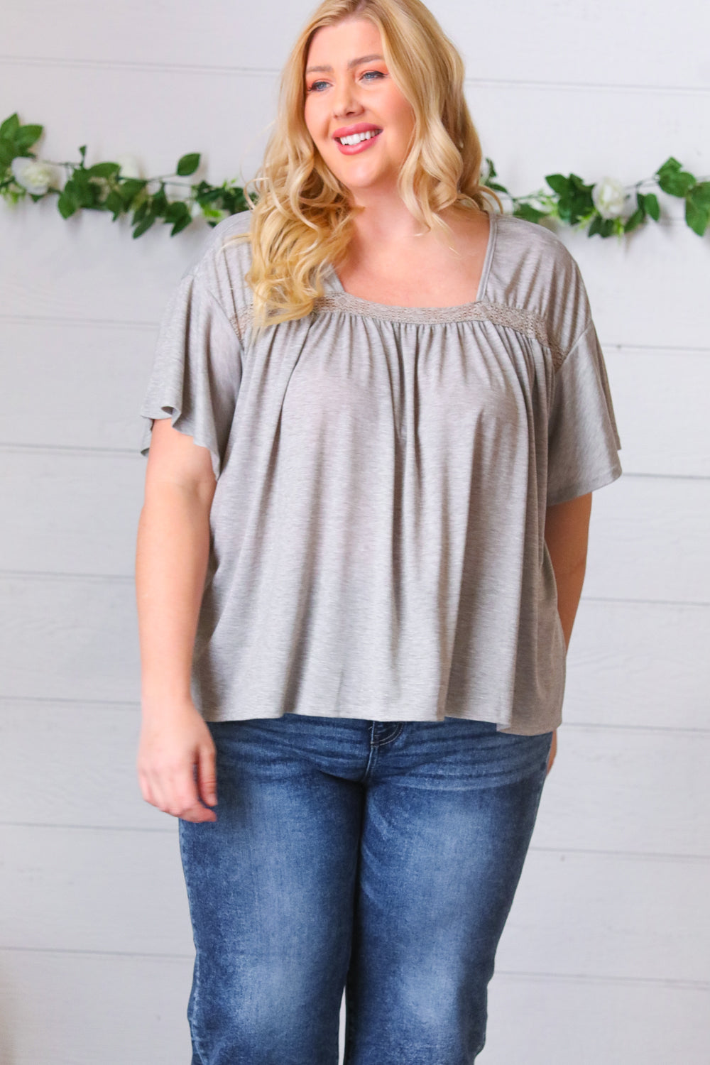Gray loose-fitting crochet top with flutter sleeves and tie back square neckline