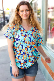 Blue & Orange Flat Floral V Neck Top | Daverri Fashions