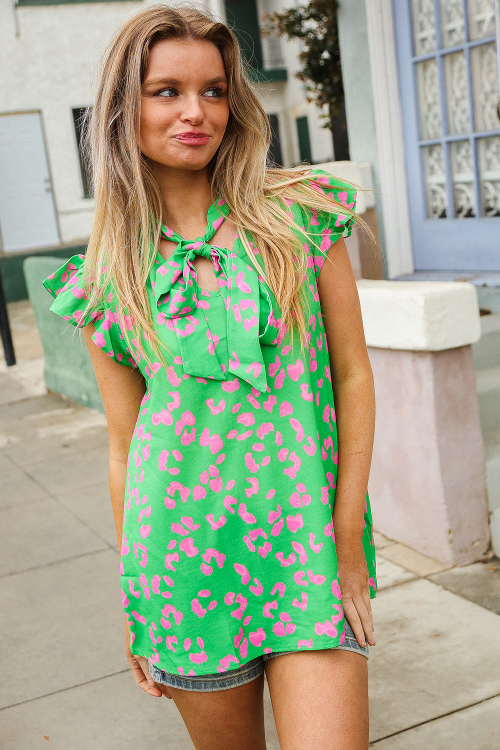 Vibrant green animal print bow tie flutter sleeve top