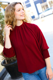 Bold Dreams Wine Smocked Three Quarter Sleeve Tie Back Top | Daverri Fashions
