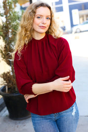 Bold Dreams Wine Smocked Three Quarter Sleeve Tie Back Top | Daverri Fashions