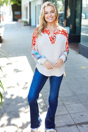 White red floral embroidered blouse with bell sleeves and denim jeans