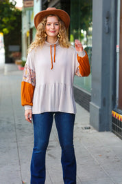 Orange and white patterned sleeve blouse with drawstring hem in taupe and rust turtleneck babydoll terry top