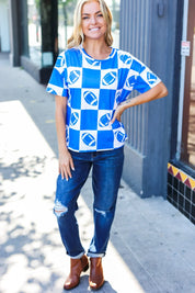 Turn Up The Volume Blue Football Checker Print Top | Daverri Fashions