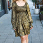 Gold metallic pleated mini dress with long sleeves and ankle boots