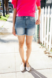 Dark Denim Mid rise raw frayed hem denim shorts | Daverri Fashions