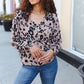Soft pink leopard-print v-neck button-up blouse with long sleeves