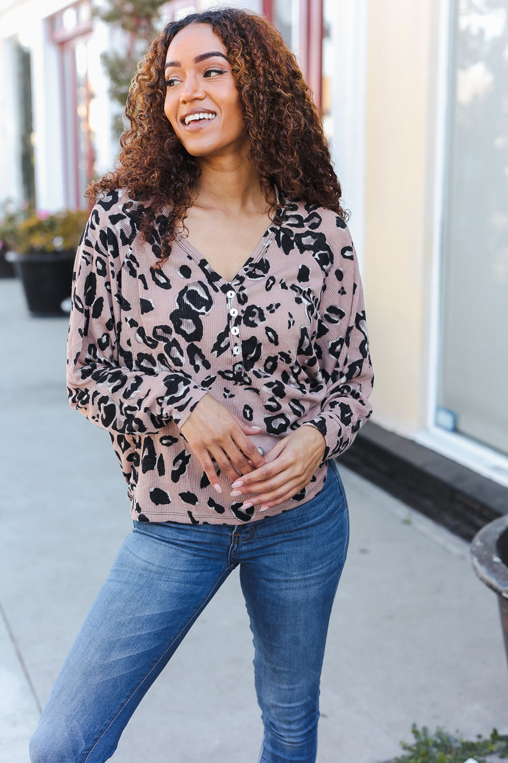 Soft pink leopard-print v-neck button-up blouse with long sleeves