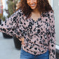 Pink leopard-print long-sleeved henley top with black spots