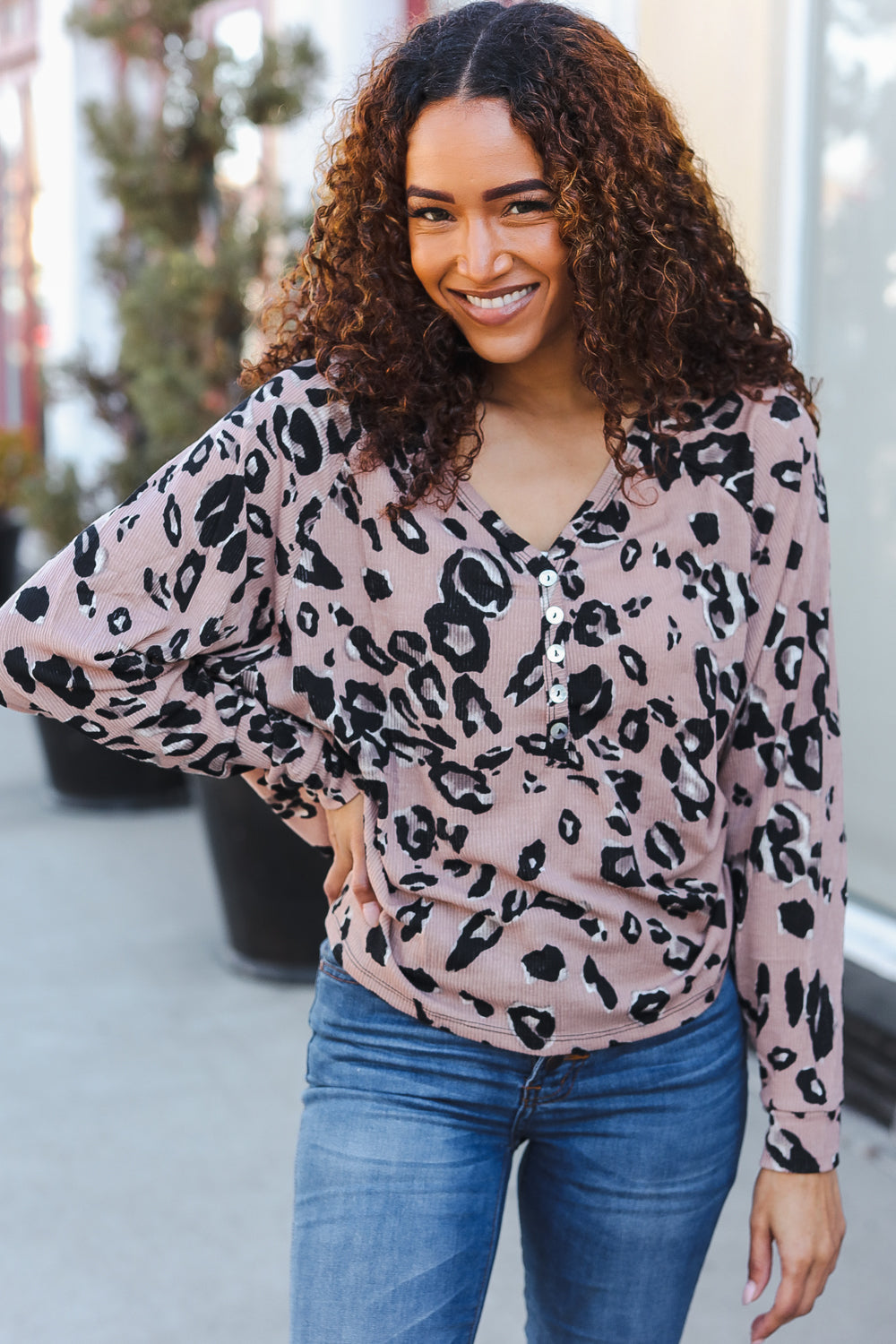 Pink leopard-print long-sleeved henley top with black spots