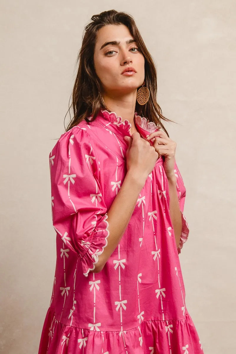 Vibrant pink BiBi ribbon pattern scallop edge short sleeve dress with white bows and ruffles