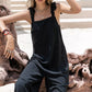 Black sleeveless wide leg jumpsuit with tie shoulder straps