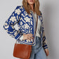 Brown leather crossbody bag with flower print jacket