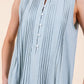 Light blue sleeveless midi dress with pintuck pleats and white buttons