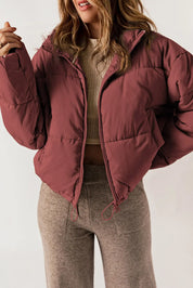Maroon quilted puffer jacket with zip-up collared neck and long sleeves