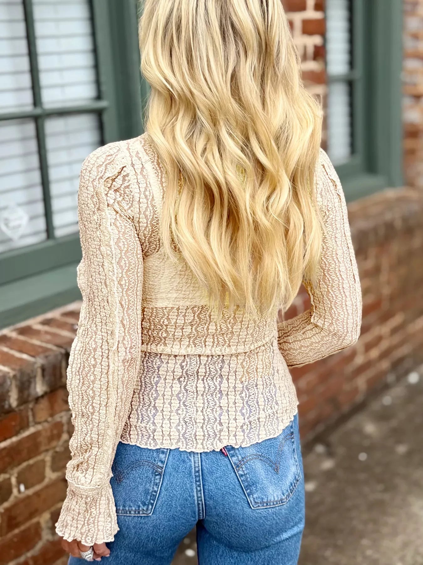 Beige lace long-sleeve blouse with ruffled cuffs and smocked waistband