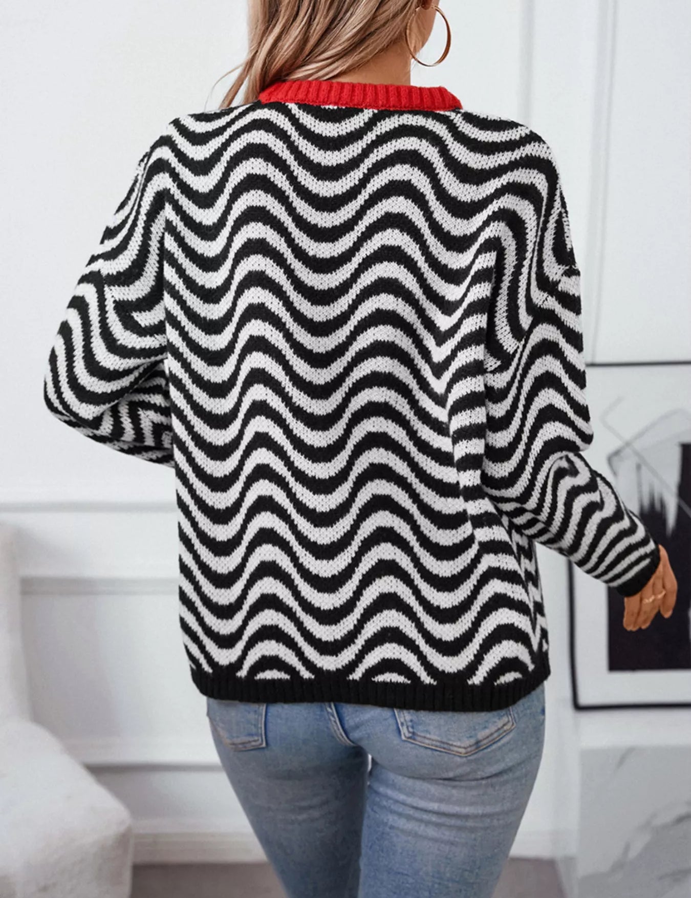 Black and white wavy striped round neck sweater with red trim