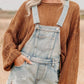 Distressed denim overalls shorts in light-wash with frayed hem